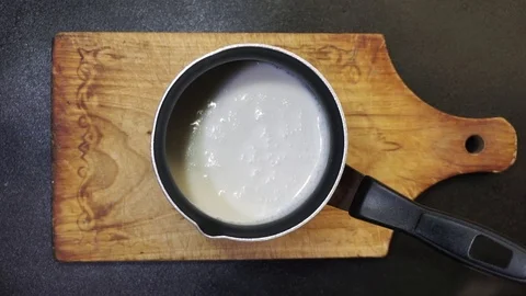 Putting chocolate to milk Stock Footage 97411278