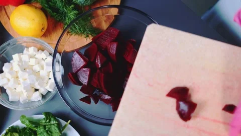 Putting chopped beetroot in a deep bowl Stock-Footage 252470495
