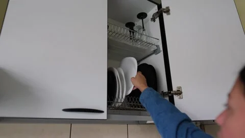 Putting clean plates into kitchen cupboard, simple home lifestyle scene 스톡 동영상 320421718