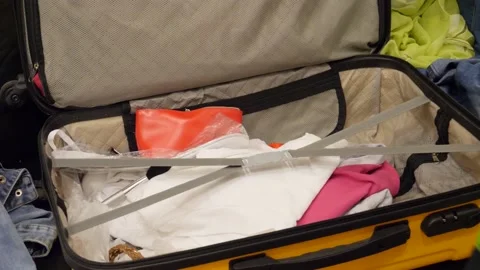 Putting clothes in bag Stock Footage 148835436