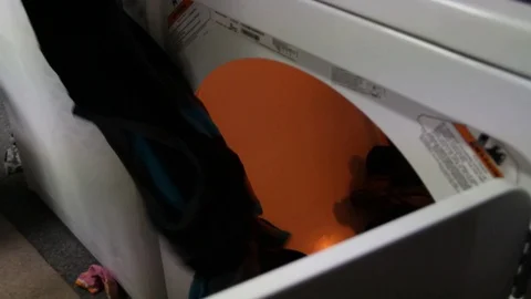Putting clothes in dryer Stock Footage 79049391