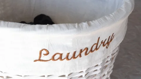 Putting clothes in the laundry basket Stock Footage 88125735