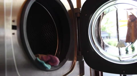 Putting clothes to a washing machine Stock Footage 67998620