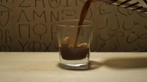 Putting coffee into a glass Stock Footage 60799436