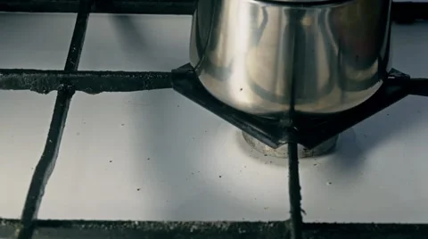 Putting coffee precolator on a gas ring Stock Footage 60799426