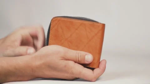 Putting condom into a wallet Stock Footage 173621258