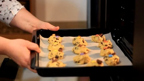 Putting cookies in the oven Stock Footage 104690059
