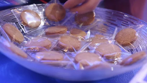 Putting cookies on a plate Stock Footage 129273381
