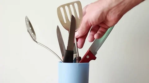 Putting cooking spoon into the plastic can Stock Footage 76996144