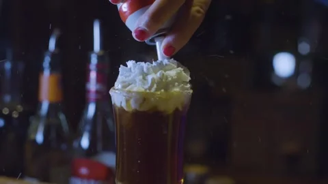 Putting cream on a cocktail Stock Footage 286249905