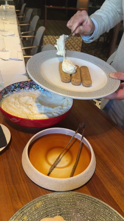 Putting cream on sponge biscuits for tiramisu dessert Stock Footage 340581319