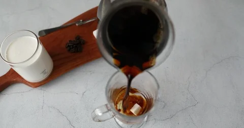 Putting cube sugar and coffee in glass cup and stirring to melt Stock Footage 119426157