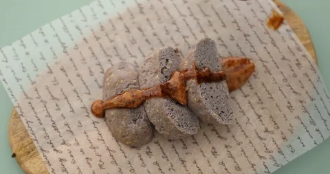 Putting Dalgona(caramel) sauce on bread for dessert Stock Footage 129719384