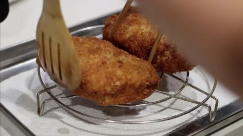 Putting deep fried pork chop in a rack, 4k, homemade food, cinematic Stockbeeldmateriaal 252168224