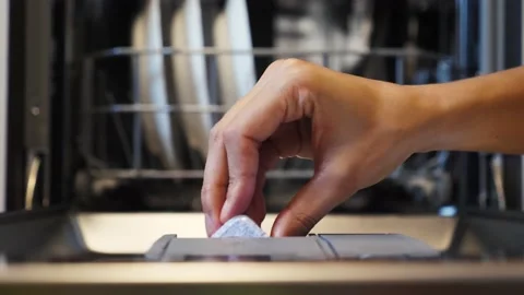 Putting detergent capsule into the dishwasher machine Video stock 145971178