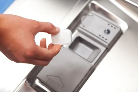 Putting Detergent Into The Dishwasher 写真素材
