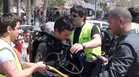 Putting diving helmet on a diver Stock Footage 48871684