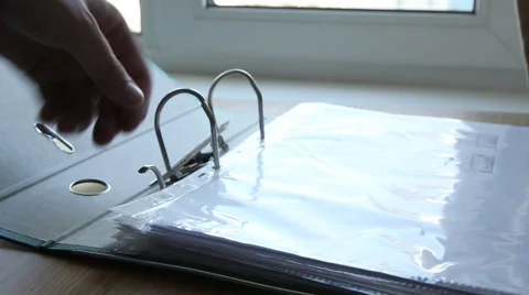 Putting a document in a holder Stock Footage 49998306