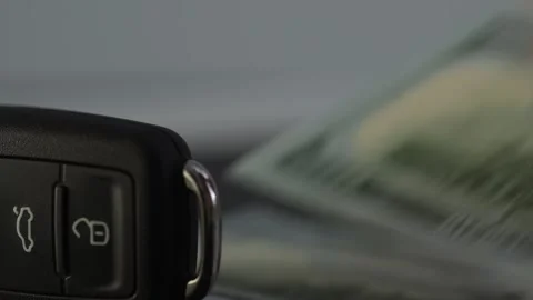 Putting Dollars Bills behind the Car Key. Stock Footage 265855422