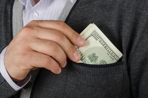 Putting dollars to pocket Stock Photos