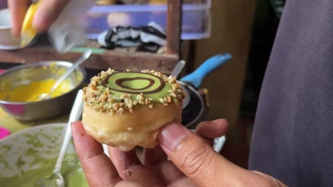 Putting donut in chocolate dipper Video stock 308639647