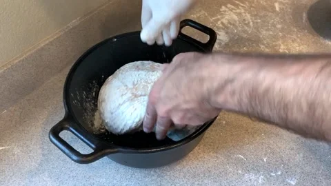 Putting Dough in a Preheated Pot to Bake Bread Stock Footage 134215171