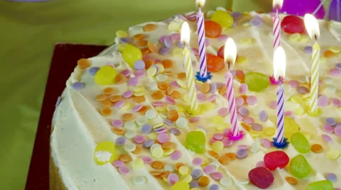 Putting Down a Birthday Cake and Blowing out the Candles Stock Footage 61942713