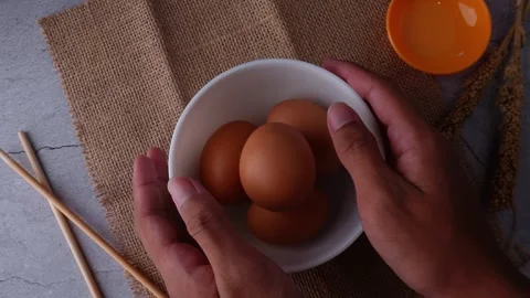 Putting down a bowl of eggs Stock Footage 273567054