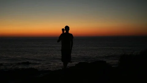 PUTTING DOWN THE CAMERA ON SUNSET Stock Footage 97995641