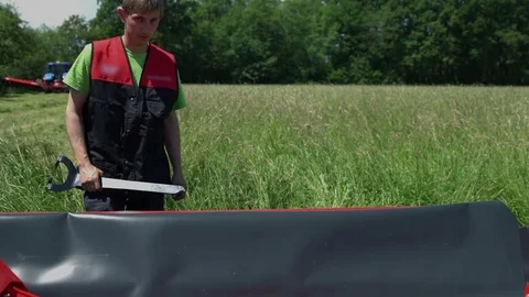 Putting down one small missing part and attaching it to the rest of the machine Stock Footage 71797519