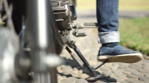 Putting down the stand for the motorbike Stock Footage 333604499