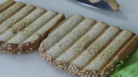 Putting dressing on bread Stock Footage 130061442