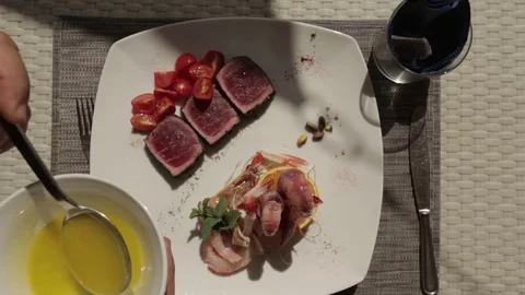 Putting dressing sauce on a fish dish Stock Footage 71618824