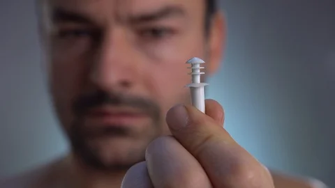 Putting ear plugs into her ears getting rid on noise in loud place. Stock Footage 101556030