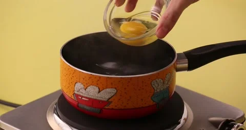 Putting egg in boiling water and stirring it 2 Stock Footage 132147101