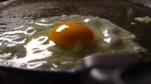Putting egg on hot frying pan slow motion video Stock-Footage 56142695
