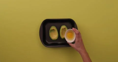 Putting eggs in the avocado 1 Stock Footage 132149595