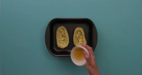 Putting eggs in potato halves 1 Stock Footage 132149334