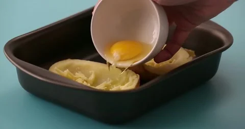 Putting eggs in potato halves 2 Stock-Footage 132149363