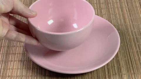 Putting empty pink plate and bowl on bamboo table mat Stock Footage 260807554