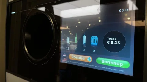 Putting empty plastic bottles to recycle in a recycling statiegeld machine Stock Footage 283447585