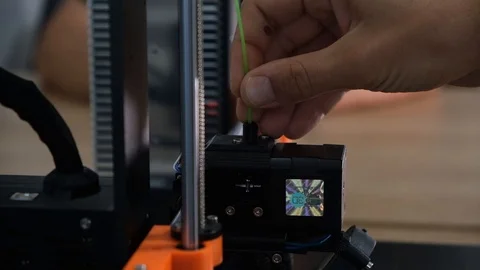 Putting filament in 3D printer Stock Footage 113344780
