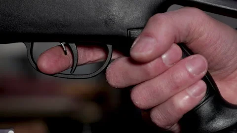 Putting finger on the trigger and gripping pistol grip. Stock Footage 297341178