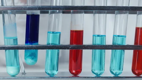 Putting a flask with blue solution in stand with other mixtures close-up. Modern 库存影片 156750713