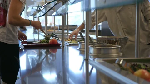 Putting food onto a tray from a buffet Stock Footage 103883697