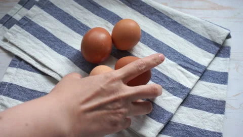 Putting fresh eggs on a table to make a breakfast Stock Footage 131856761