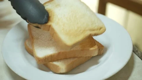 Putting fresh toasted bread into white plate ready for healthy meal Stock Footage 209124226