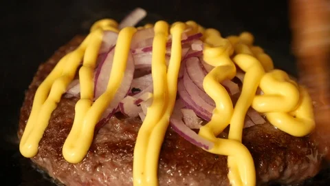 Putting fried bacon and cheese on a burger Stock Footage 113155594