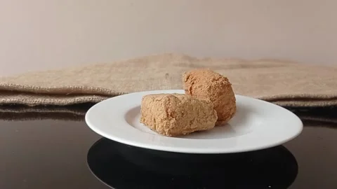 Putting the fried brown tofus on the small white plate Stock Footage 150398021
