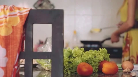 Putting fried egg on slice of bread, kitchen table with ingredients Stock-Footage 77904250